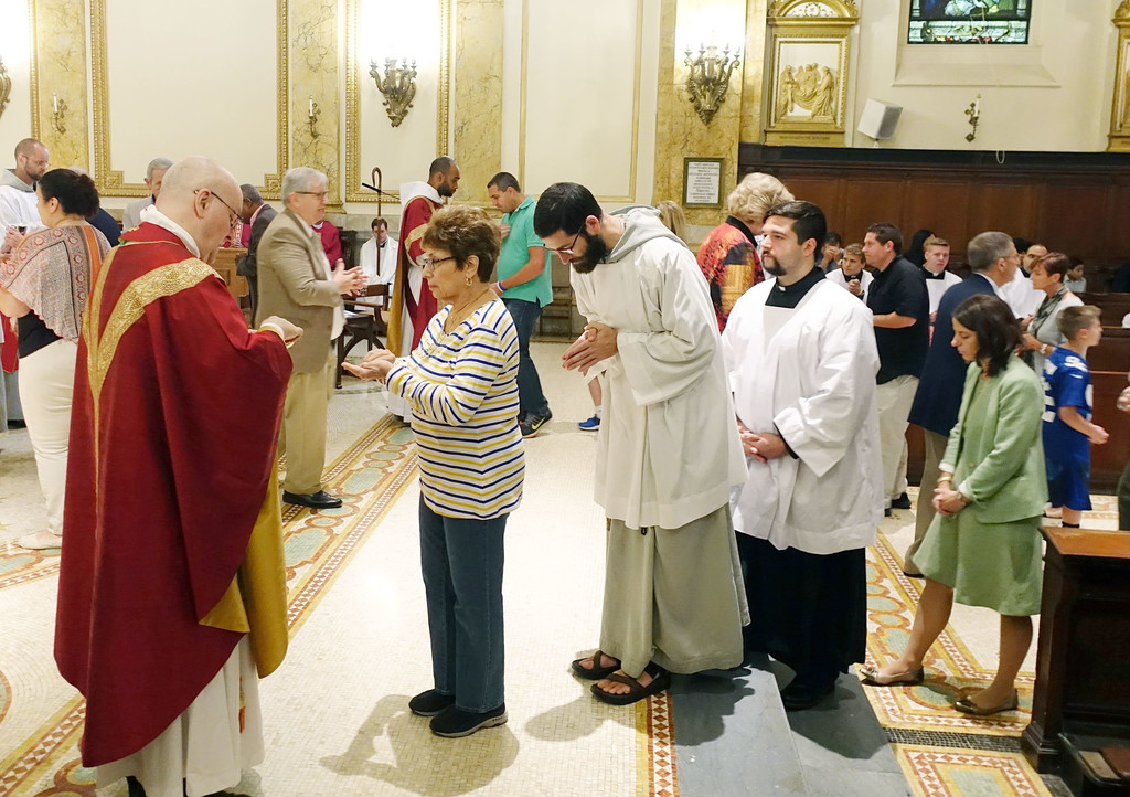 Brooklyn Auxiliary Bishop James Massa distributes Communion during the Mass of the Holy Spirit Sept. 10 marking the start of the academic year at St. Joseph’s Seminary in Dunwoodie. Others enrolled in master’s degree programs at the seminary, including clergy, religious and lay people as well as men in formation for the permanent diaconate, joined in the day, which included a picnic.