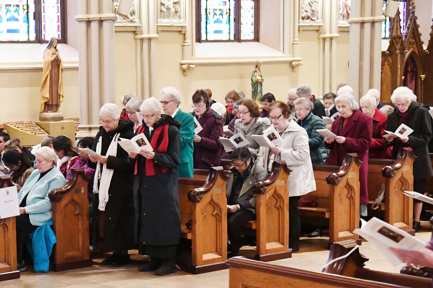The Sisters of Charity celebrate the 200th anniversary of their arrival in New York at a Mass Dec. 9 at the Basilica of St. Patrick’s Old Cathedral. Top left, some sisters stand and renew their vows.