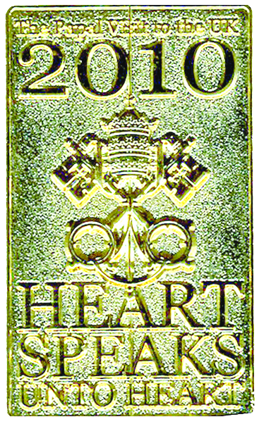 KEEPSAKE—Gold-tone pin bears Blessed Newman’s motto, which was theme of papal visit: “Heart Speaks Unto Heart.” Cardinal Egan wore pin in England to signify admittance to all papal events.