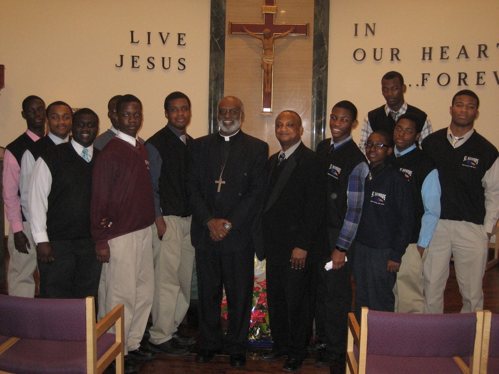 VISITOR—Archbishop Charles Palmer-Buckle of Accra, Ghana, stands with teacher Moses Alabi and students of Ghanaian descent, during a Feb. 8 visit to the St. Raymond High School for Boys in the Bronx.