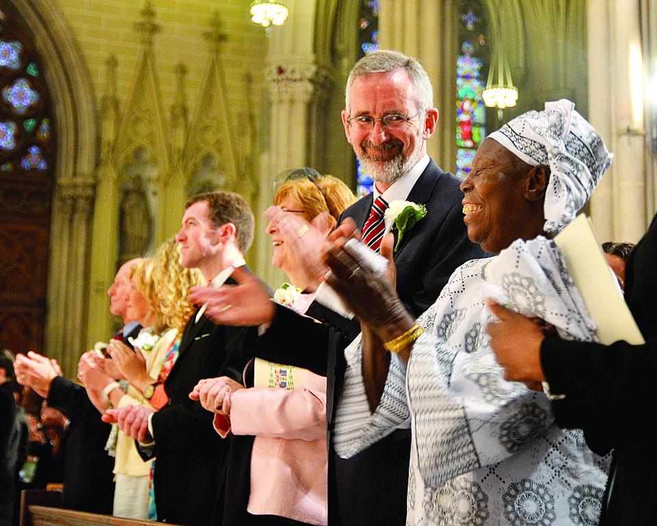 HEART OF THE FAMILY-The cathedral resounded with applause for the newly ordained at the conclusion of Mass. Joining in, in foreground, are Zita Kasigwa Mung’aho of Tanzania, mother of Father Casmir Mung’aho, and Maeve and Robert Jordan, of Dublin, Ireland, parents of Father Columba Maria Jordan, C.F.R.
