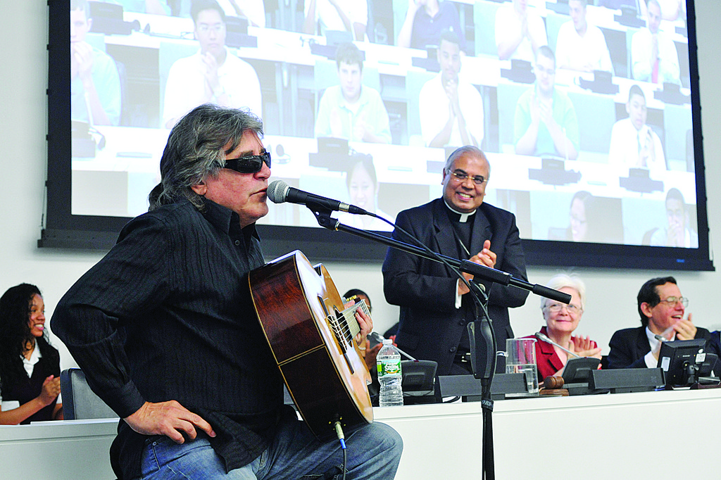SPIRITED—Singer Jose Feliciano performs at the United Nations June 3 during event marking the International Year of Youth as Archbishop Francis A. Chullikatt, the Vatican nuncio to the U.N., applauds in the background.