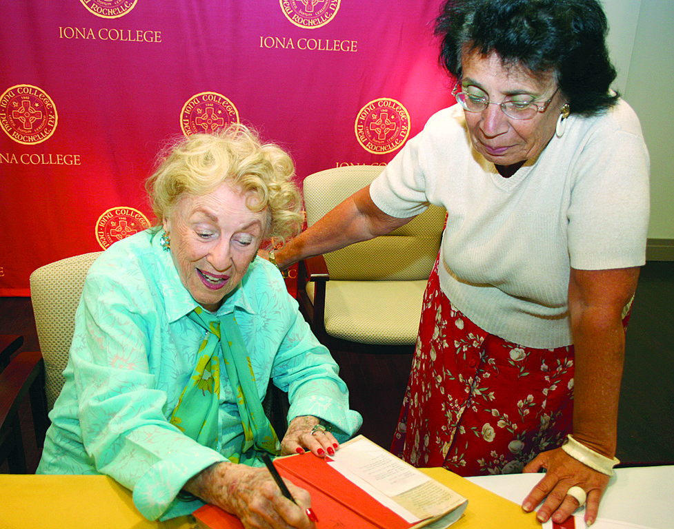 GOOD REVIEW—Author Bel Kaufman signs an original copy of her book "Up the Down Staircase" for program participant Nancy Russo.