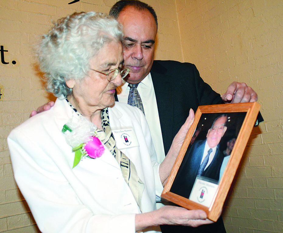 MOTHER AND SON—Marcelina Marrero, along with her son, Gabriel, looks lovingly at photograph of her husband of 74 years, Vicente, at World Marriage Day Mass. Vicente Marrero died two days before the Feb. 12 Mass at St. Patrick’s Cathedral.