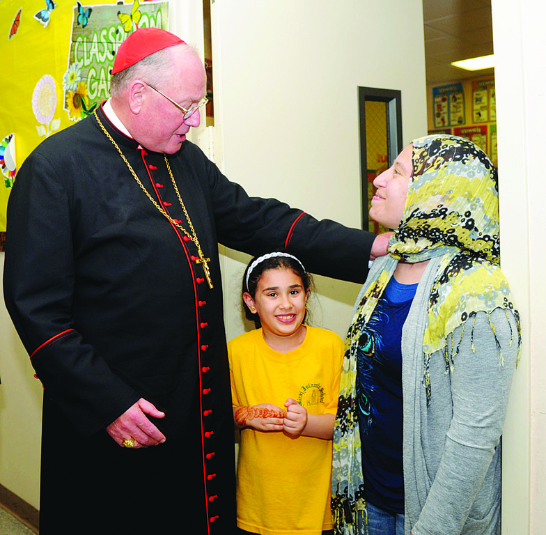GREETING—Cardinal Dolan chats with second-grade student Zaineb Ghazaz, and her mother, Anna Ghazaz, who is the second-grade teacher at the Albanian Islamic Cultural Center on Staten Island June 19.