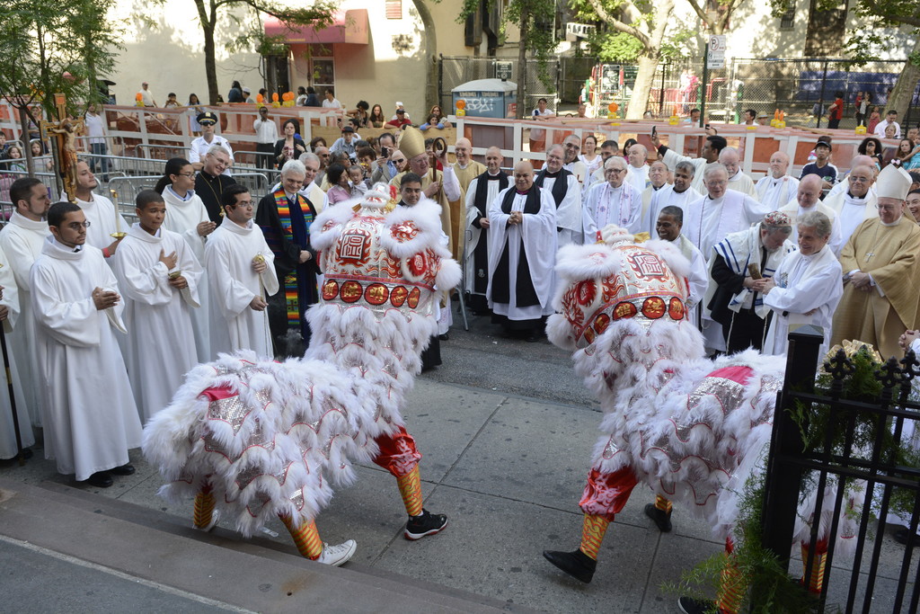 Devotion and multi-cultural dance play a part in the liturgy and the street reception outside St. Teresa’s Church.