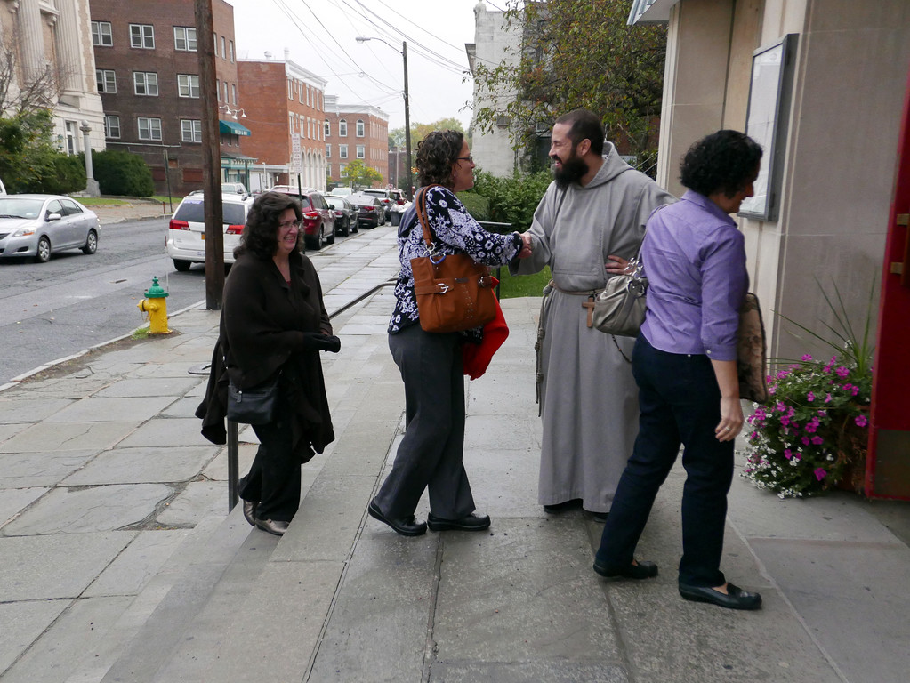 Brother Philip Maria Allen, C.F.R., greets people outside St. Patrick’s Church.