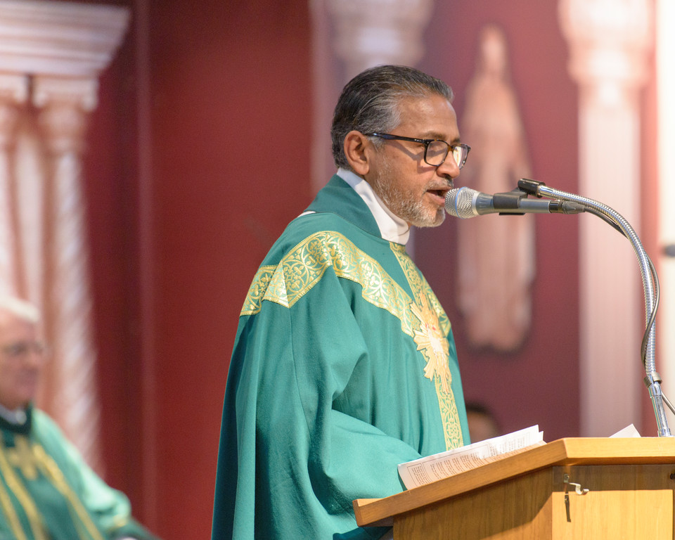 Father Thadeus Aravindathu, administrator of St. Boniface, addresses the congregation.