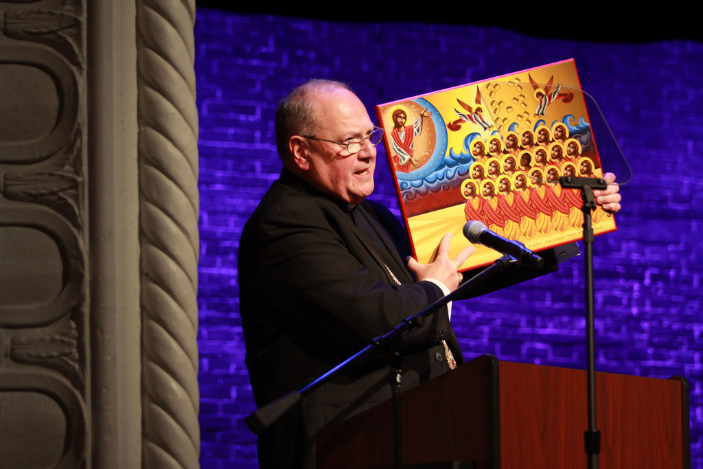 Cardinal Dolan displays an icon of the martyrs of Libya while delivering closing remarks at the interfaith forum “The Crisis for Christians in the Middle East” on Dec. 5 at the Sheen Center in Lower Manhattan.