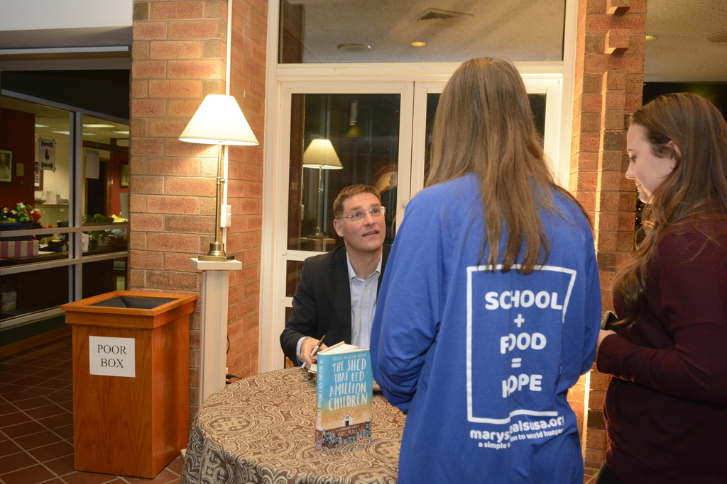 Magnus MacFarlane-Barrow, founder and CEO of Mary’s Meals, signed his book, “The Shed That Fed a Million Children,’’ following his talk at St. Stephen the First Martyr Church in Warwick on Dec. 14. Money raised from book sales was donated to Dzungwi Primary School in Malawi, the parish’s adopted school, via Mary’s Meals.