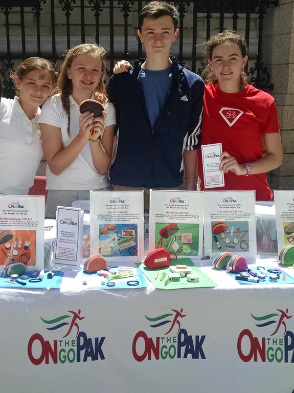 Carina, Daniella, John and Francesca Kehoe sell “On the Go Paks” at a street fair held at Convent of the Sacred Heart in Manhattan last May. The siblings sell the packs, filled with daily accessories, to raise money for scholarships for girls to attend Sacred Heart High School in Uganda.