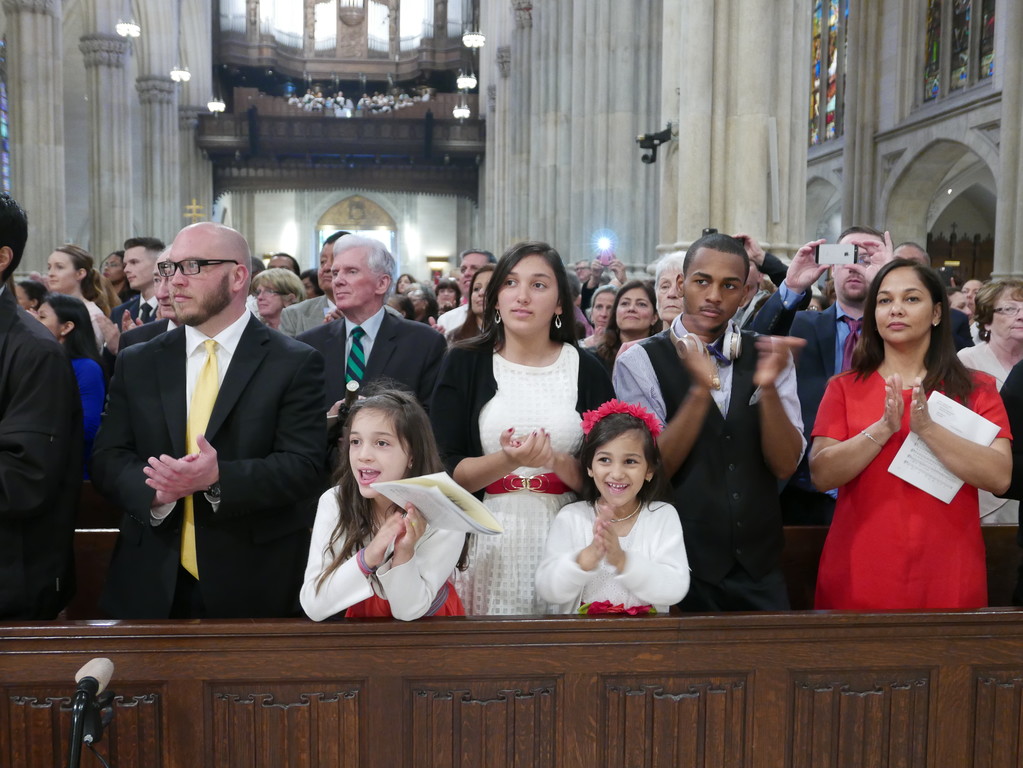 PROUD—Family members and friends of the new deacons eagerly display their joy and enthusiasm at the Mass of Ordination.