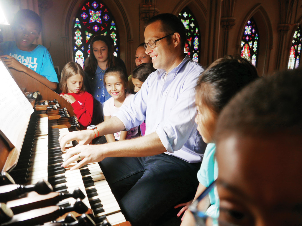 MUSIC MAKERS—Jared Lamenzo, organist at the Basilica of St. Patrick’s Old Cathedral in Lower Manhattan, plays the parish’s 1868 Henry Erben Pipe Organ for an audience of appreciative youngsters July 26 during the parish’s five-day music camp, aptly titled Pipes, Pedals & Peals. Organizers hope to make the music camp an annual summer program.