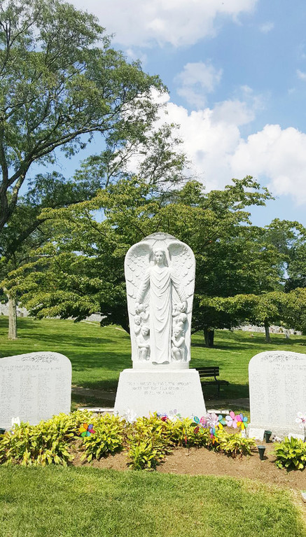 The Guardian Angel section at Gate of Heaven Cemetery in Hawthorne includes communal markers to the left and right with the names of the babies buried there.