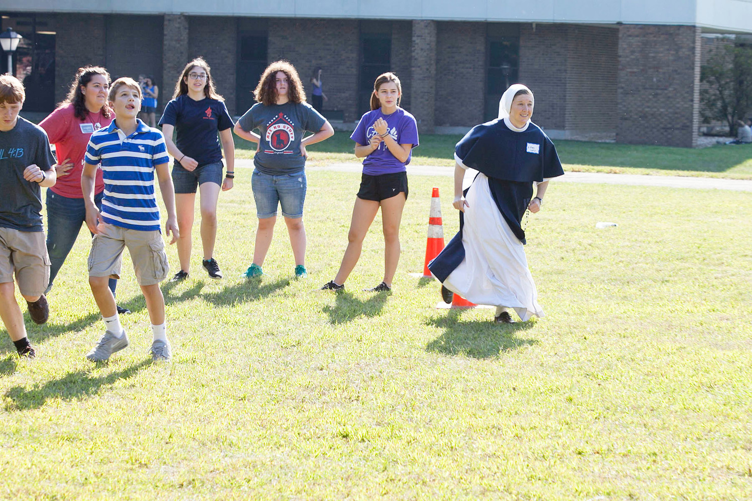 Sister Mary Casey, S.V., joins teens for a game of Frisbee football.