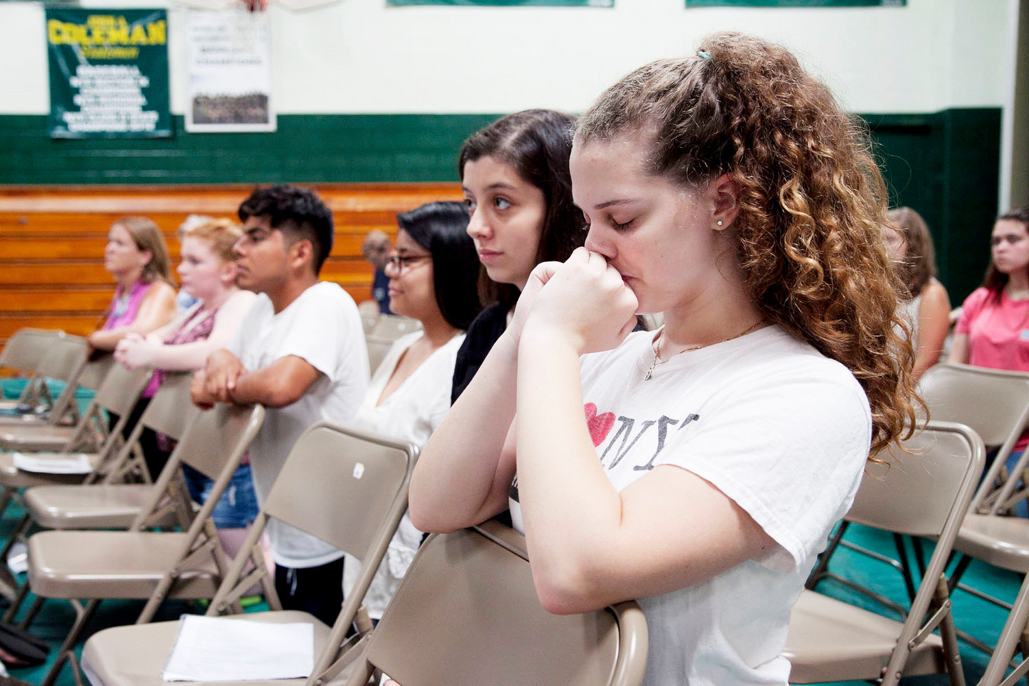 Olivia McArdle prays with her fellow campers during Mass celebrated by Auxiliary Bishop Peter Byrne.