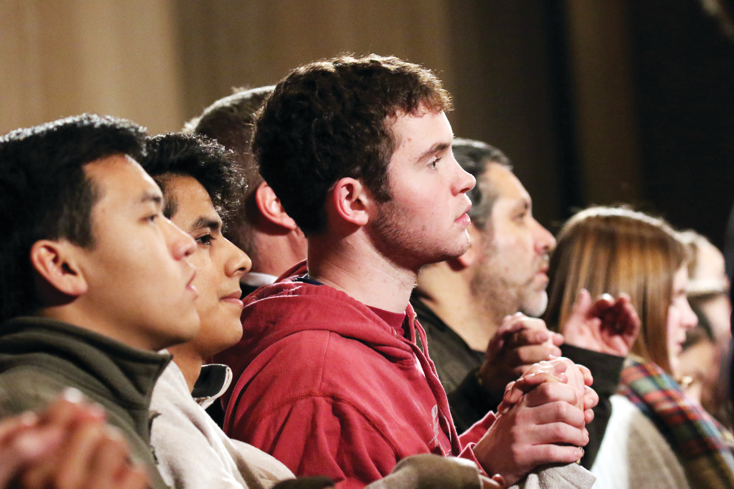 Young people join hands as they pray the Lord’s Prayer during the opening Mass of the National Prayer Vigil for Life at the Basilica of the National Shrine of the Immaculate Conception in Washington, D.C., Jan. 18.