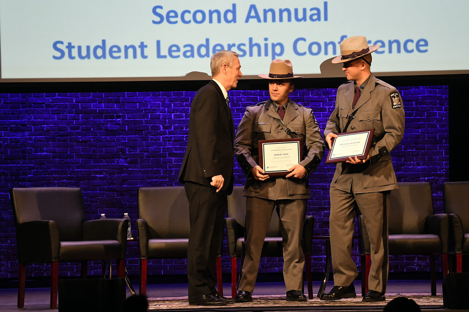 New York state troopers Robert Troy and Thomas Karasinski receive the 2018 Faithful Citizenship Award from Dr. Timothy J. McNiff, superintendent of schools in the archdiocese, during the second annual Student Leadership Conference at the Sheen Center for Thought & Culture in Manhattan March 5.