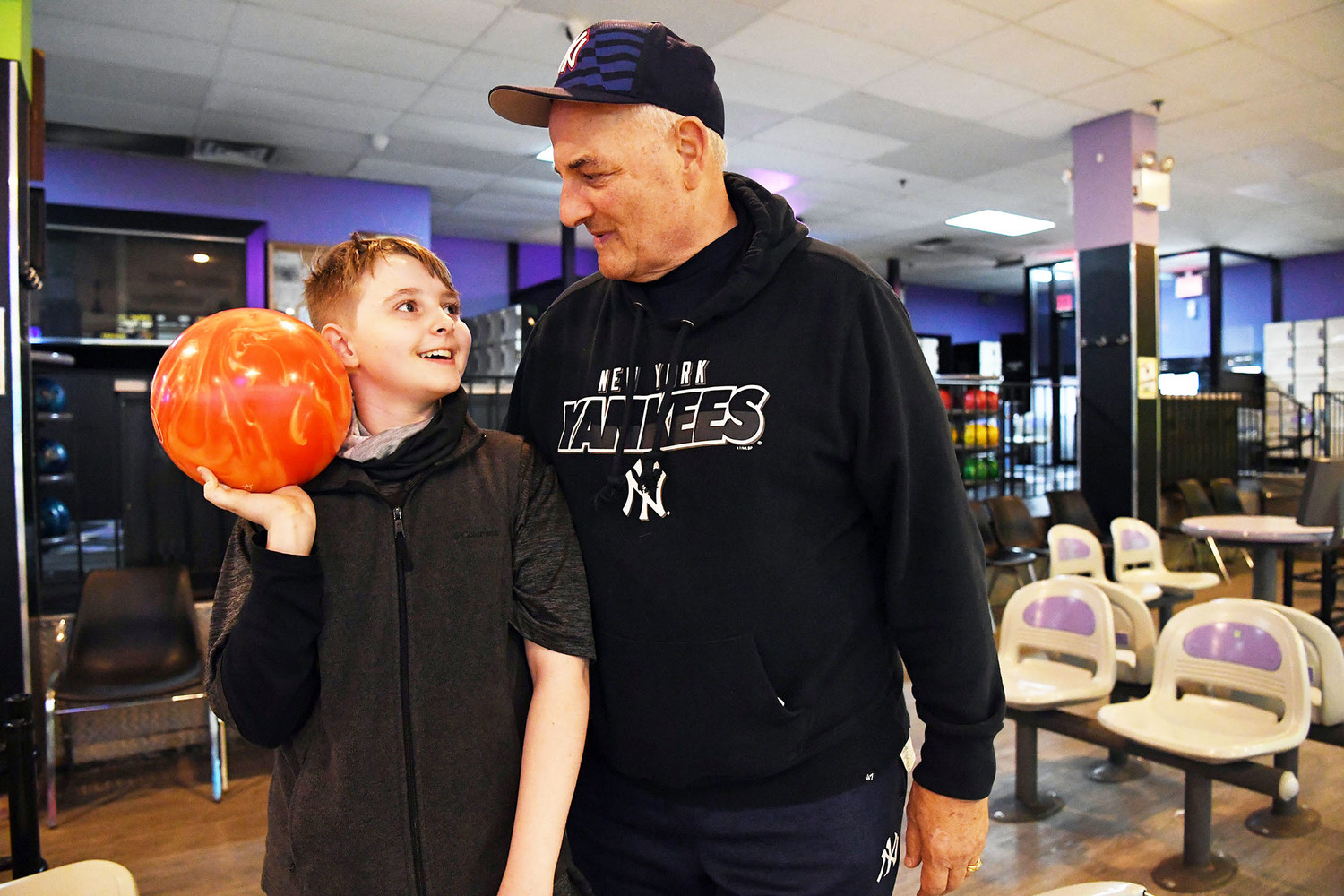 Jack Harkin, a sixth-grader at Intermediate School 24 on Staten Island, smiles with his grandfather Larry Ambrosino at Rab’s Country Lanes April 17. Harkin, who started bowling last year, looks forward to spending time with his grandfather each Tuesday as he competes in the Staten Island CYO bowling league.