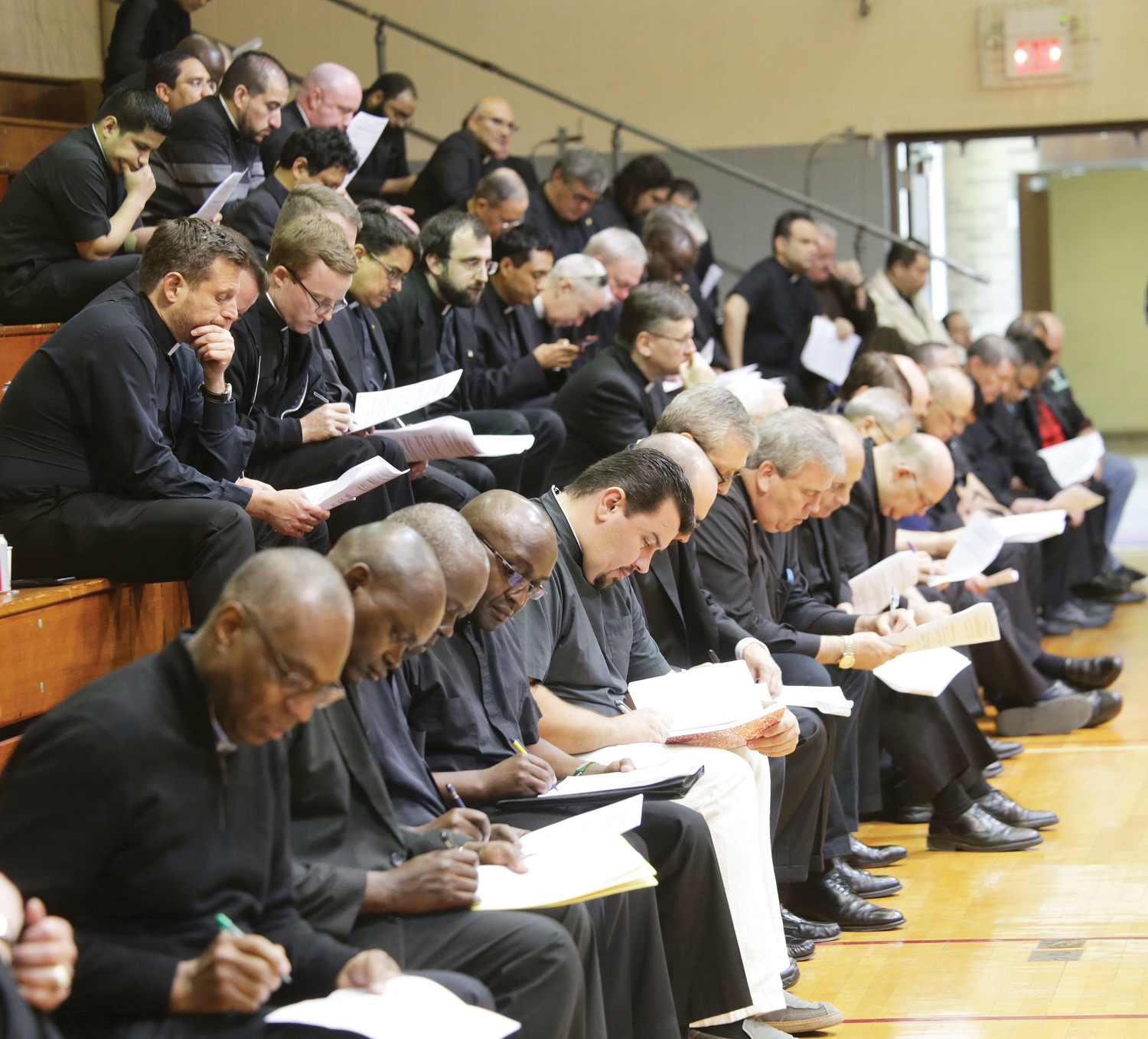 PASTOR TO PASTORS—New York priests take careful notes on handout materials during the second session of the Safe Environment Convocation, at which Pastor Rick Warren spoke on “Maintaining the Moral Integrity of the Ministry to Which God Has Called Us.” Nearly 800 priests heard the Evangelical pastor June 6-7 at Cardinal Spellman Center at St. Joseph’s Seminary in Dunwoodie.