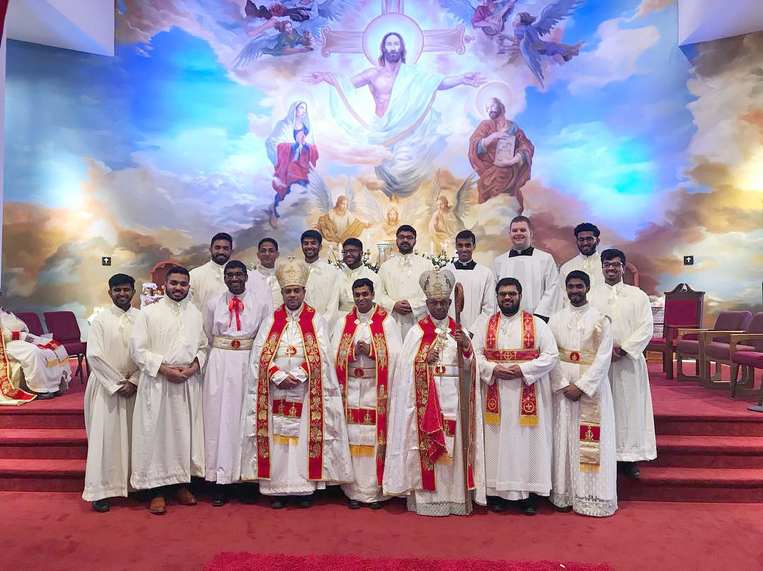 CALLED—Father Kevin Mundackal, center, following his ordination May 5. To his left is Auxiliary Bishop Mar Joy Alappat and to his right is Bishop Mar Jacob Angadiath, both of the St. Thomas Syro-Malabar Catholic Diocese of Chicago. Far right in first row is Father Rajeev Valiyaveettil Philip, ordained June 2.