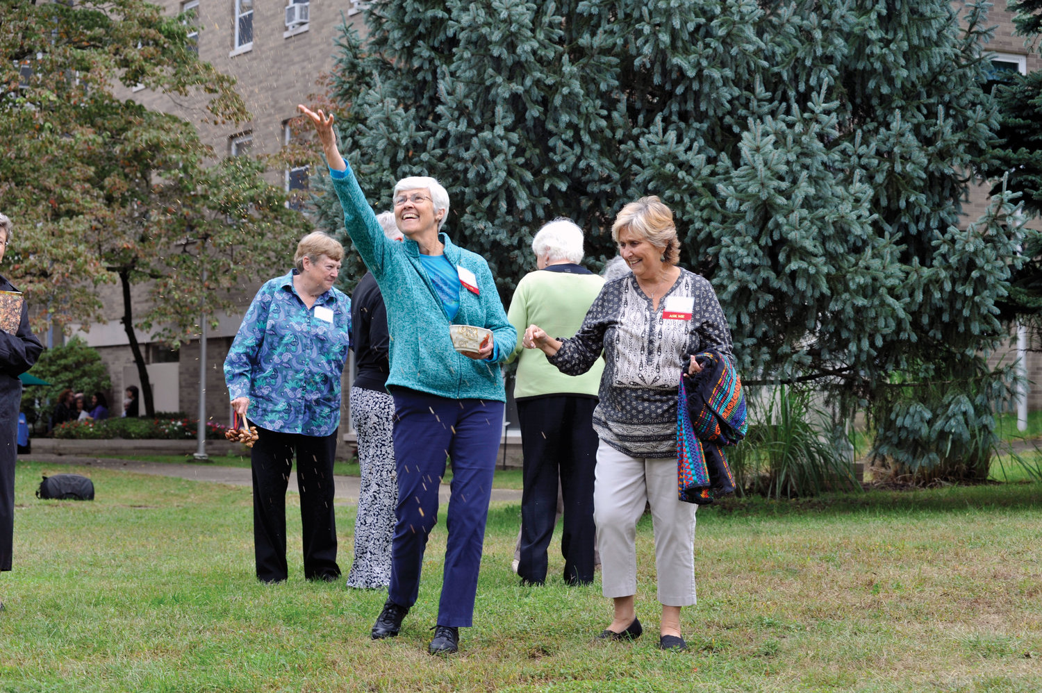 Sister Bette Ann Jaster, O.P., tosses seeds into the air at Mariandale following a Sept. 28 press conference in which the Dominican Sisters of Hope announced a conservation easement to prevent future development of 34 of the 61 acres on their Ossining property.