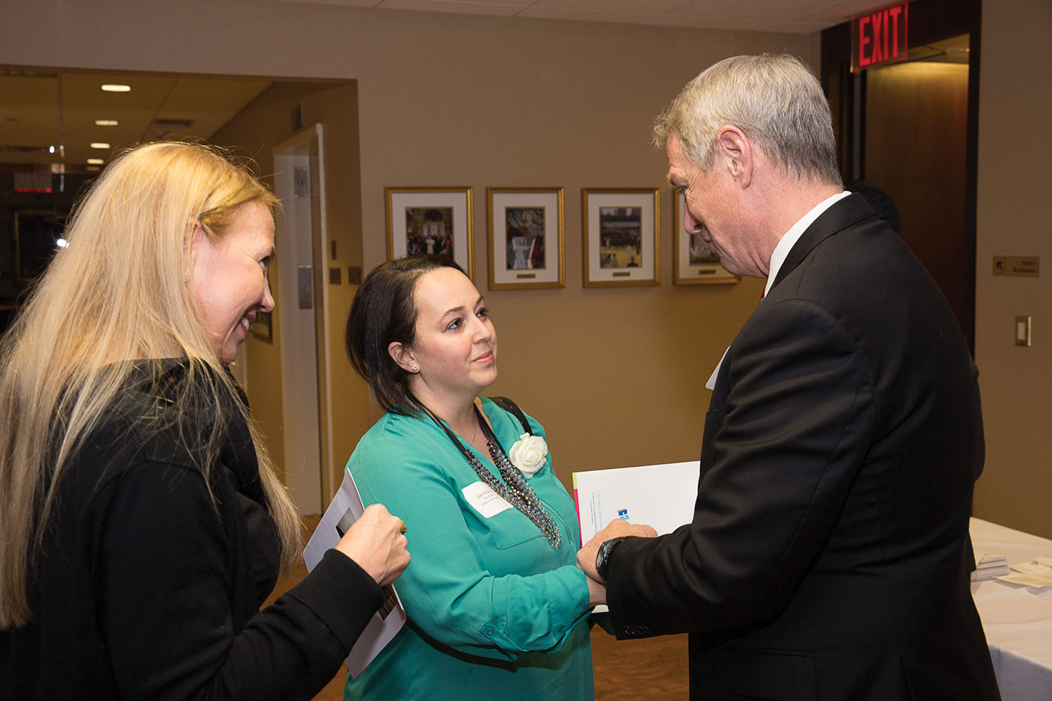 Dr. Timothy McNiff, superintendent of schools, greets Curran Fellowship candidate Joanna Moore, center, of Resurrection School in Rye, and GinaMarie Fonte, principal of Resurrection School.
