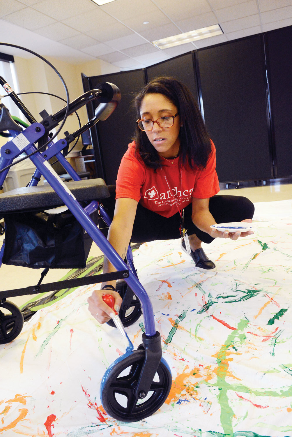 Staff, including Rebecca Love, recreational services supervisor, assisted the seniors March 25 in applying assorted colors of paint before the artists wheeled their modes of transportation across a canvas.