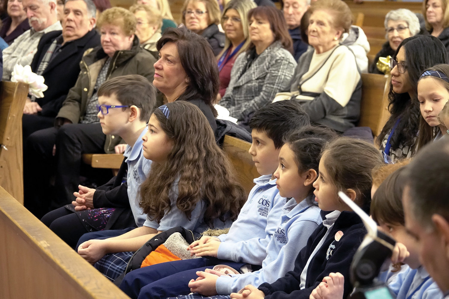 Students, other members of the school and guests attend Mass Cardinal Dolan offered at Immaculate Conception Church before he toured the school and attended a reception there.