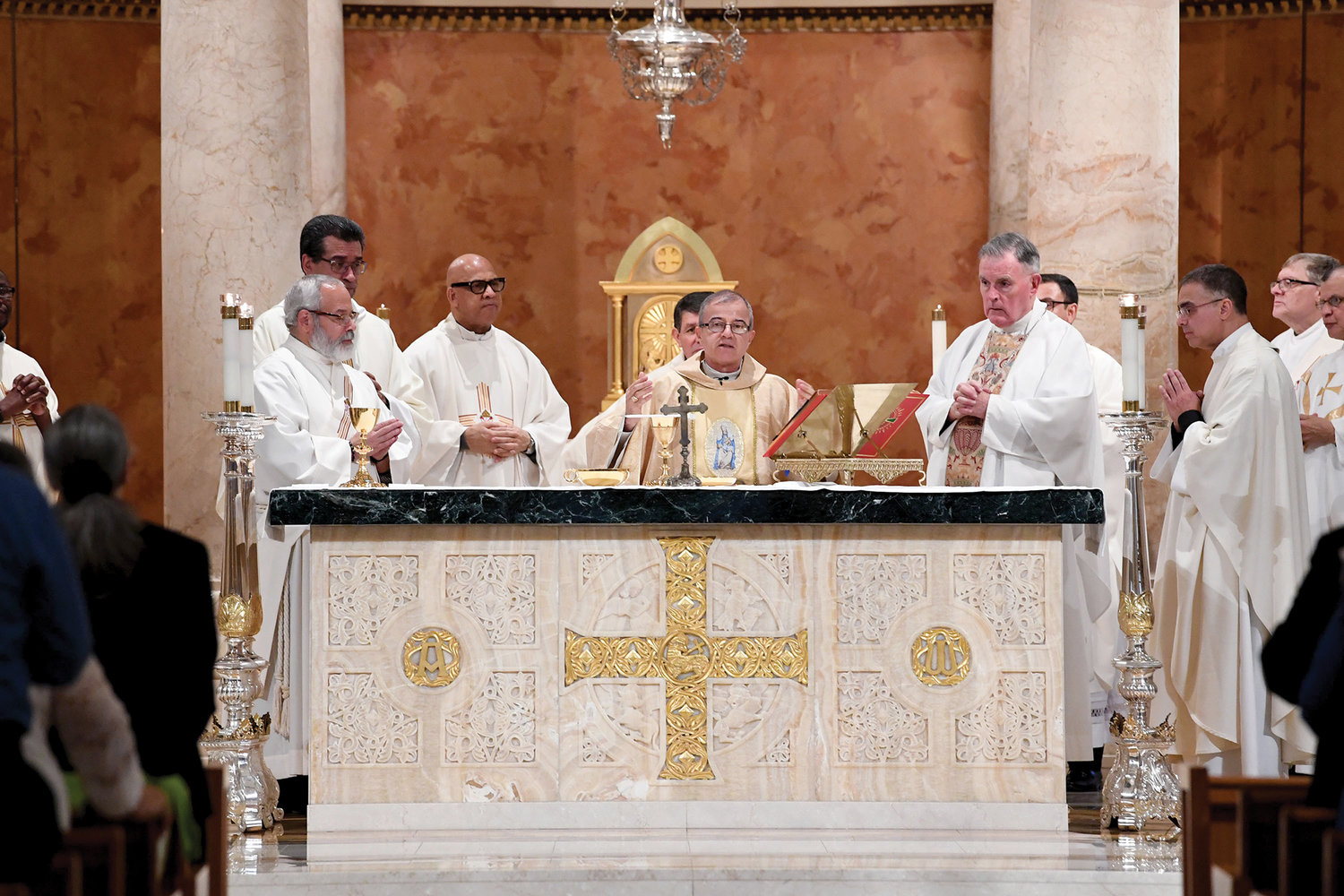 Archbishop Roberto Gonzalez of San Juan, Puerto Rico, celebrates a Solemn Mass for the People of Puerto Rico Feb. 2 at St. Raymond Church in the Bronx. The liturgy served as a sign of solidarity after the recent earthquakes that struck the Caribbean island. Auxiliary Bishop Gerald Walsh, near the archbishop to the right, was among the concelebrants. Next to the bishop is Father James Cruz, pastor of St. Raymond’s parish.