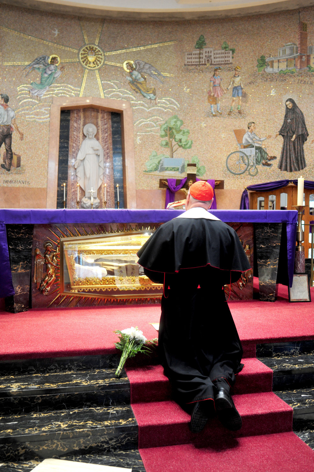 PRAYERS IN A PANDEMIC—Cardinal Dolan, kneeling at St. Frances Cabrini Shrine in Manhattan March 22, prays for healing and protection in the coronavirus pandemic that is plaguing the city, state, nation and world. The day before, he also prayed privately at two shrines dedicated to the Blessed Mother: the National Shrine of Our Lady of Mount Carmel in Middletown and the Shrine of Mary Help of Christians in Stony Point.