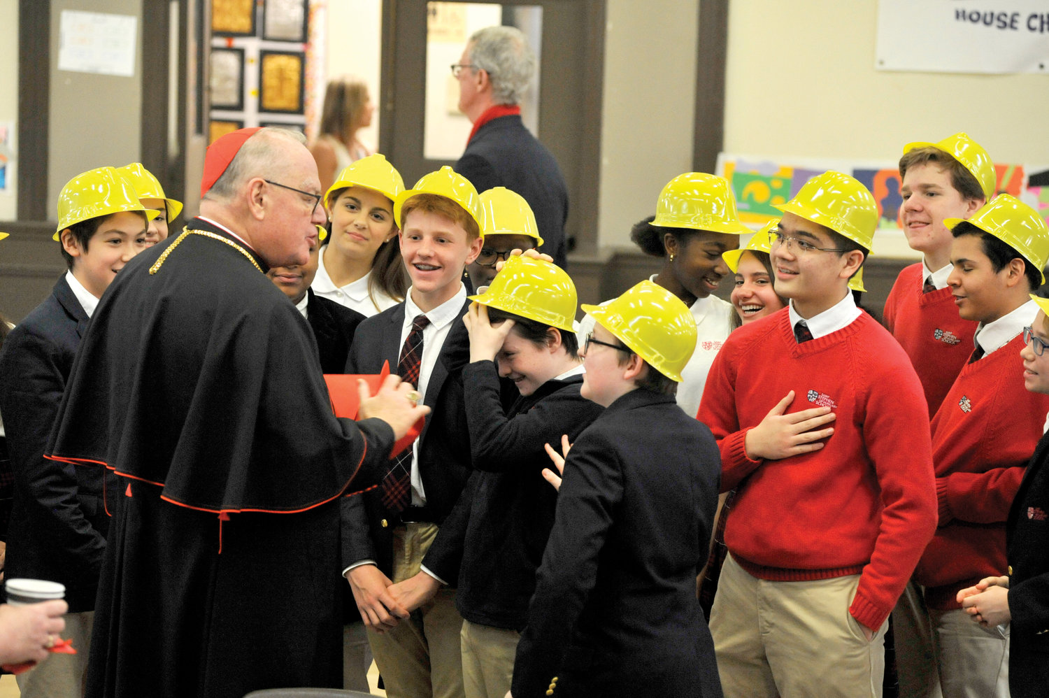 Cardinal Dolan shares a festive moment with students at St. Stephen of Hungary School in Manhattan March 11.