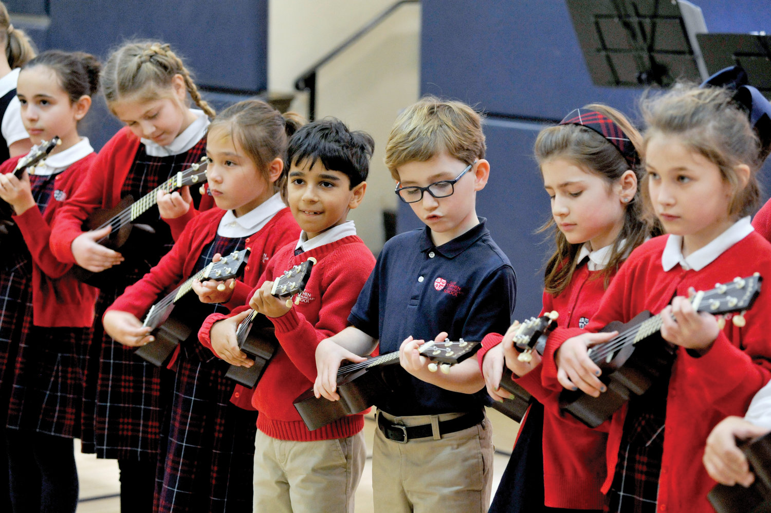 Youngsters play the ukulele during a reception.