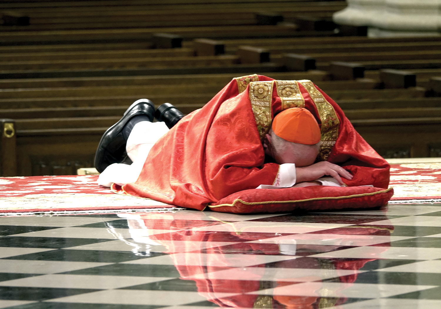 Cardinal Dolan lays prostrate in the sanctuary of St. Patrick’s Cathedral at the beginning of the celebration of the Passion of the Lord on Good Friday, April 10.