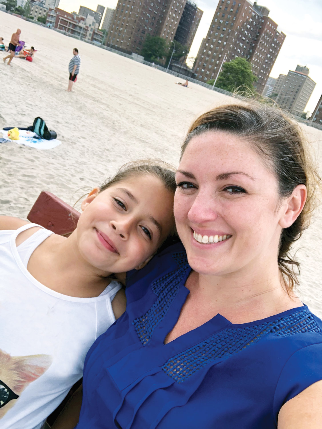 A BIG DIFFERENCE—Esmeralda, 11, above, and her mentor, Sara, relax on the beach at Coney Island last year.