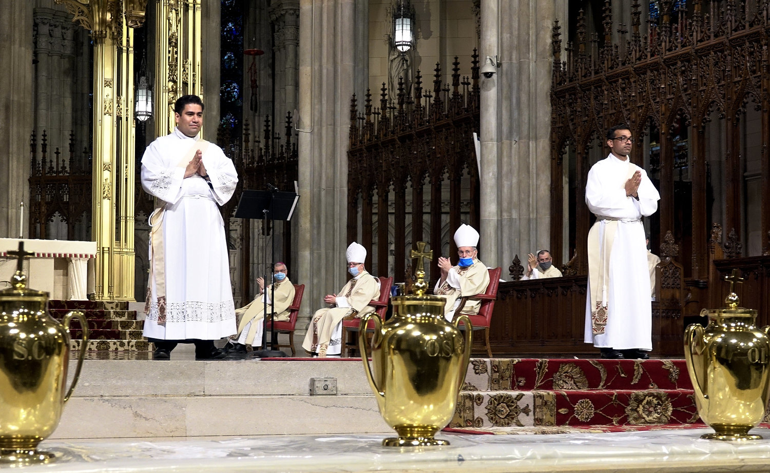 The two newly ordained priests, Father Luis Silva and Father Roland Pereira, M.Id., receive the applause of the congregation at St. Patrick's Cathedral.