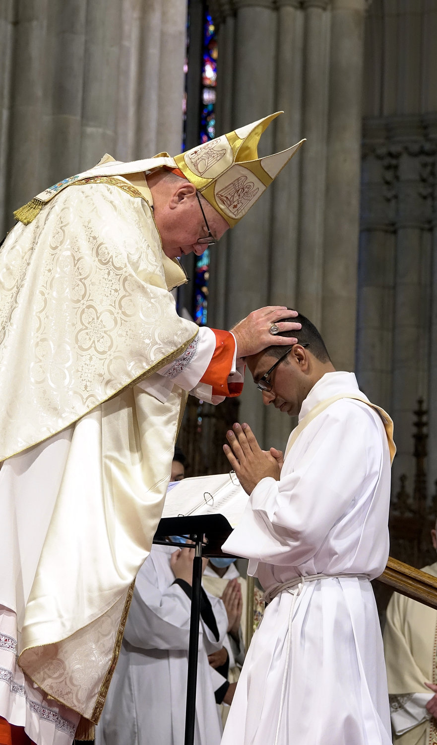 Cardinal Dolan lays hands on Father Roland Pereira, M.Id., during the Rite of Ordination.