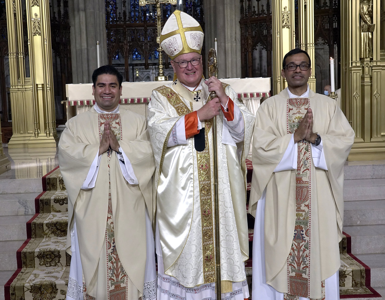 Cardinal Dolan joins Father Luis Silva and Father Roland Pereira, M.Id., after the Mass of Ordination