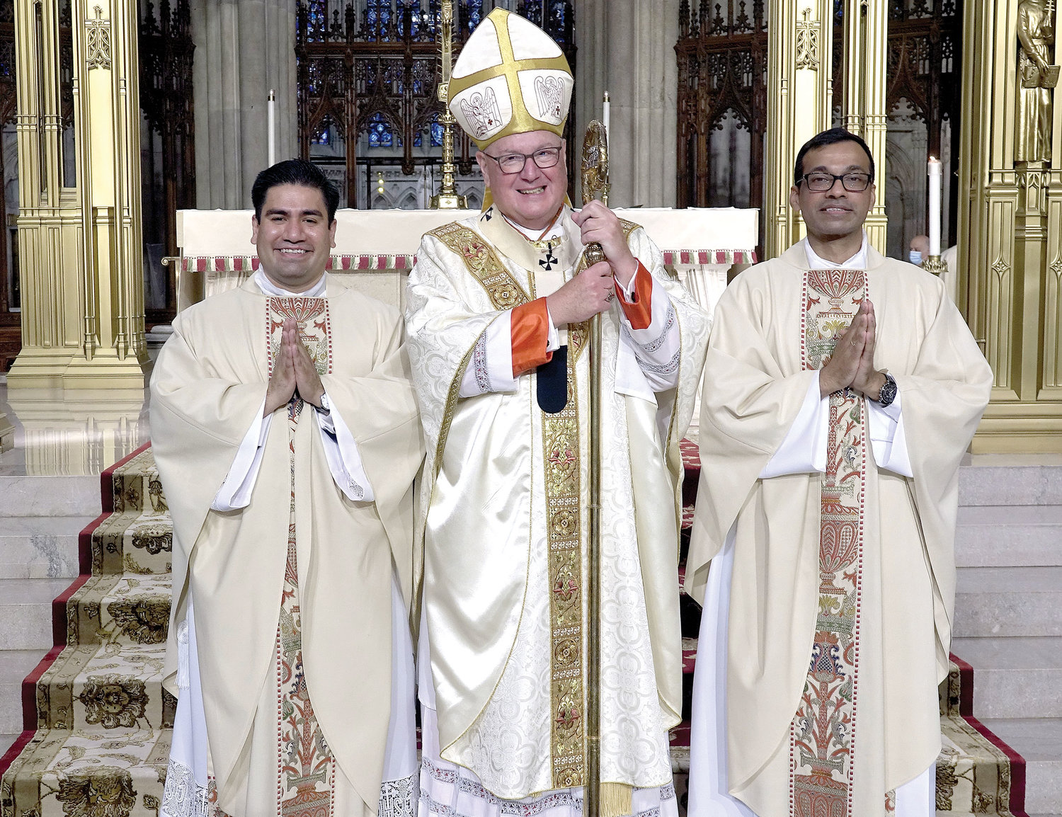 Cardinal Dolan, left, smiles alongside the two new priests he ordained—one for the archdiocese, Father Luis M. Silva Cervantes, left, and the other for the Idente Missionaries, Father Roland P. Pereira, M.Id. The cardinal served as principal celebrant at the Mass of Ordination of Priests June 26 at St. Patrick’s Cathedral.