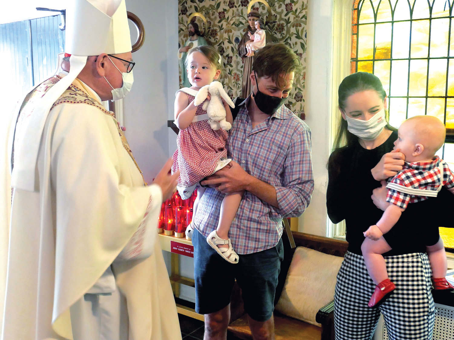 Cardinal Dolan greets Tom and Mary O’Brien and their children, 2-year-old Mary and 7-month-old William, after the Mass the cardinal offered July 19 to mark the 125th anniversary of Our Lady of Mount Carmel Church in Tuxedo.