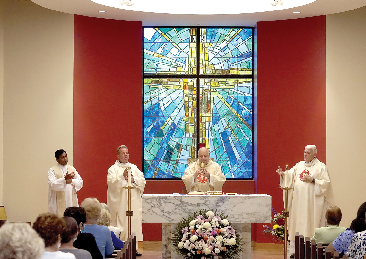 Msgr. Joseph LaMorte, vicar general and moderator of the
curia for the archdiocese, celebrates Mass marking the reopening of St. Paul’s Church in Congers Aug. 8. Standing
on the altar with Msgr. LaMorte are Father Joseph Kumar Narisetty, parochial vicar of St. Paul-St. Ann parish, far left; Father Vladimir Chripko, C.O., pastor of St. Paul-St. Ann parish; and Msgr. Emmet Nevin, dean of Rockland Deanery, right.