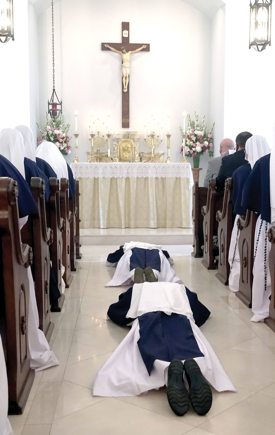 Sister Virginia Joy, S.V. and Sister Naomi Maria Magnificat, S.V., lay prostrate on the chapel floor.