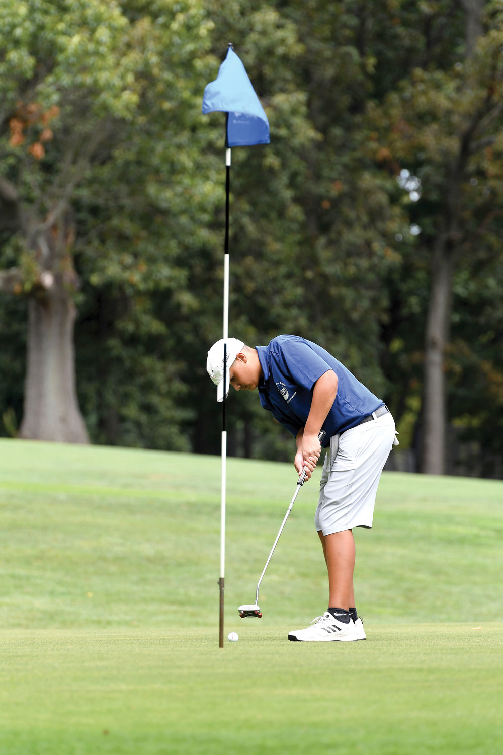 Michael Hui watches the ball head toward the eighth hole during the Dr. Theodore A. Atlas CYO Junior Golf Tournament at Silver Lake Golf Course on Staten Island Sept. 3. Hui and his teammates from Intermediate School 34 won the team championship.