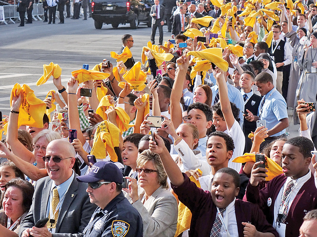 Legions of high school students from around the archdiocese line up outside Our Lady Queen of Angels School in East Harlem, where the pontiff met with students and immigrant New Yorkers.