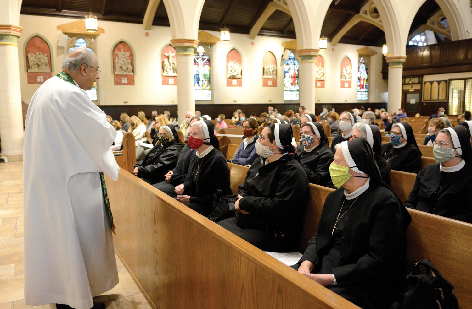Father Anthony Sorgie, pastor of Immaculate Conception and Assumption of Our Lady parish, converses with women religious of Blessed Clelia’s order before the Mass he celebrated. Approximately 30 sisters attended the liturgy, which included a blessing of the shrine.