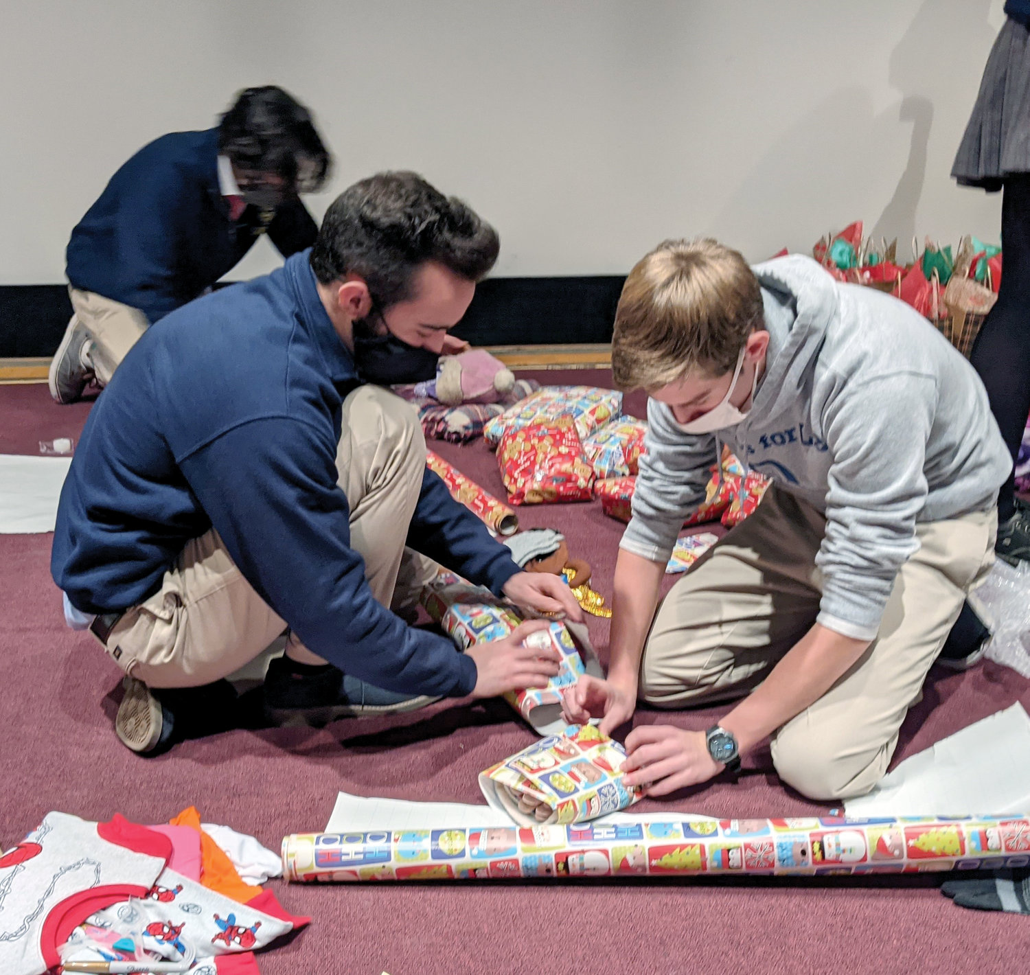 Robert Polidoro, left, and Ryan Murphy wrap gifts for Newburgh Ministry.