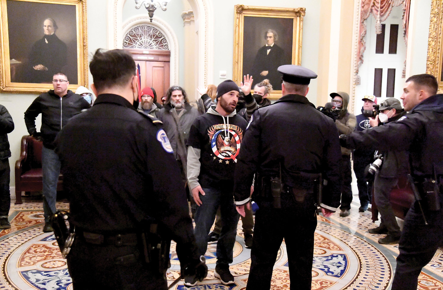 SIEGE ON CONGRESS—Police confront supporters of President Donald Trump as they demonstrate on the second floor of the U.S. Capitol building in Washington, D.C., near the entrance to the Senate after breaching security defenses Jan. 6.
