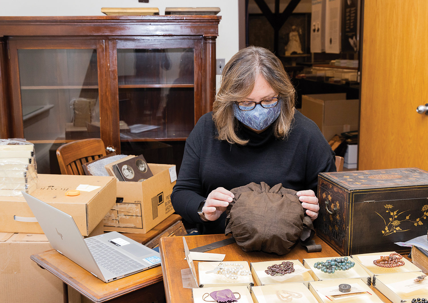 Kathleen Craughwell-Varda, museum consultant, inspects a bonnet, a rare artifact relating to the life of St. Elizabeth Ann Seton being donated by the Sisters of Charity of New York to the National Shrine of St. Elizabeth Ann Seton in Emmitsburg, Md.