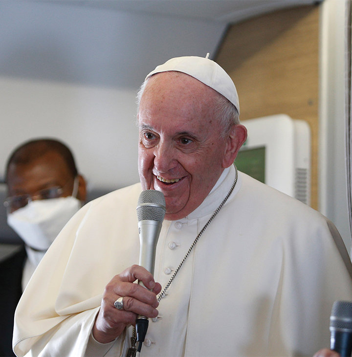 HAPPY RETURN—Pope Francis, smiling broadly, speaks with journalists aboard his flight from Baghdad to Rome March 8 following his weekend pastoral visit to Iraq.