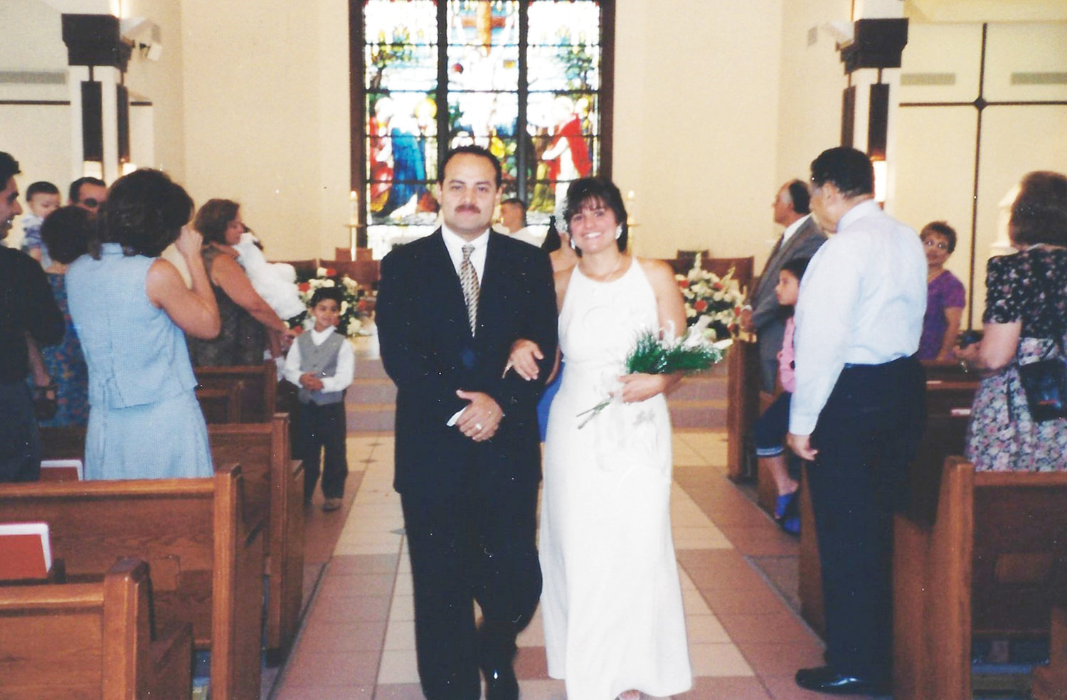 HOLY MATRIMONY—Jeff and Claudia Cortez leave Sacred Heart Church in Monroe after their church wedding on July 22, 2000. The couple, married civilly 10 years earlier, had son Alex serve as ring bearer, and daughter Jessica as flower girl at their church wedding.